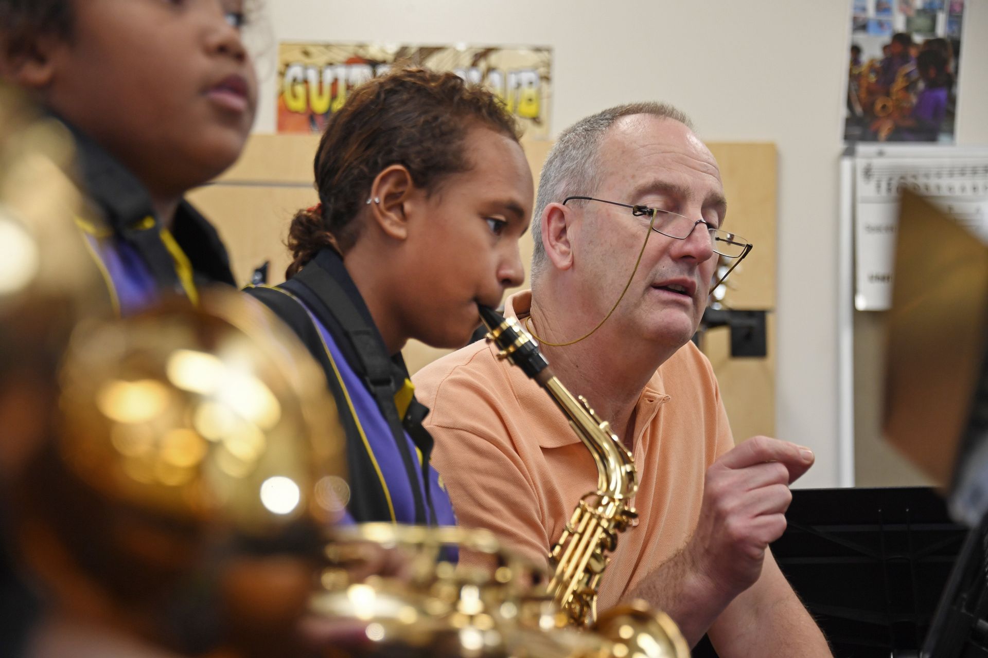Image of music teacher showing students how to play a song as part of the Australian Curriculum